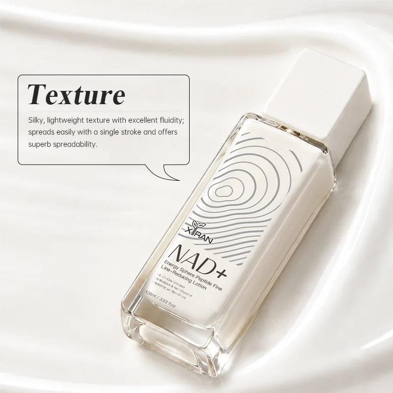 A bottle of NAD+ line-reducing lotion with a minimalist design placed on a silky white fabric background, showcasing product texture details.